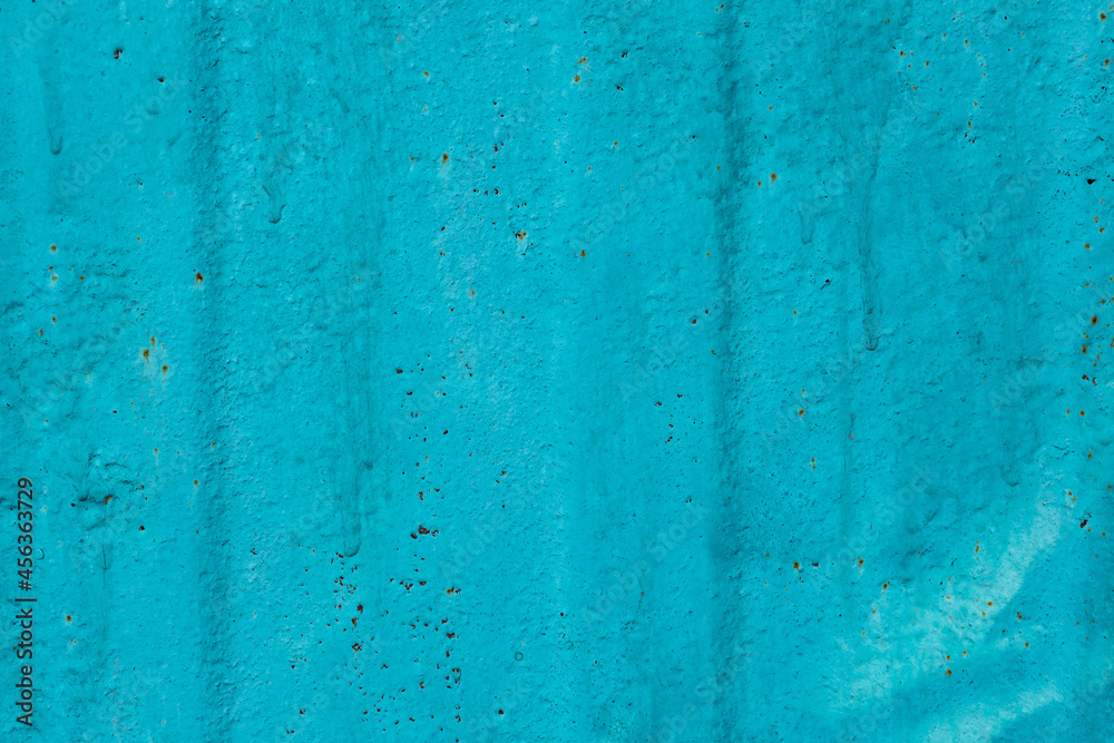 Cracked painted old metal texture. Abstract background of painted turquoise surface. Grunge blue wall background