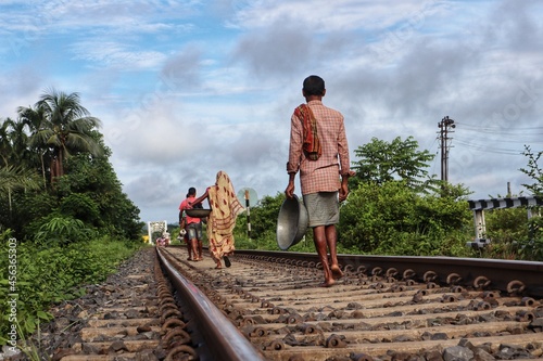 People walking to their work through the Railway Track