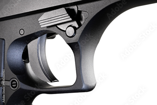 Large semi automatic handgun trigger up close with a white background photo