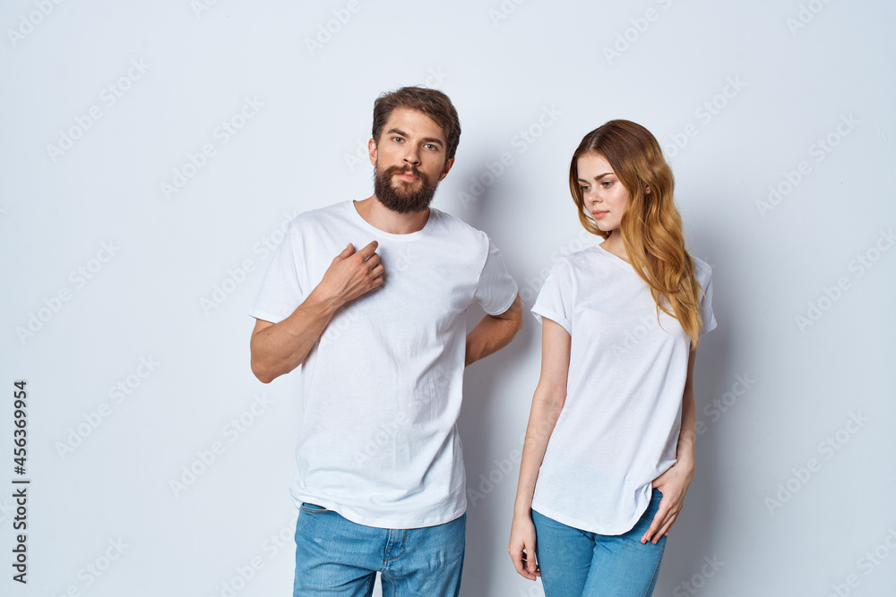 cheerful young couple in white t-shirts studio communication cheerful young couple in white t-shirts studio communication