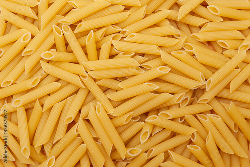 Background of raw penne pasta
