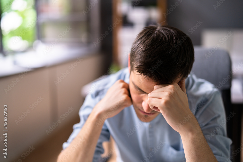 Unhappy Sad Man With Migraine Using Computer Unhappy Sad Man With Migraine Using Computer