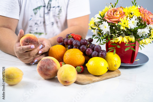 a man with flowers and fruits at the table