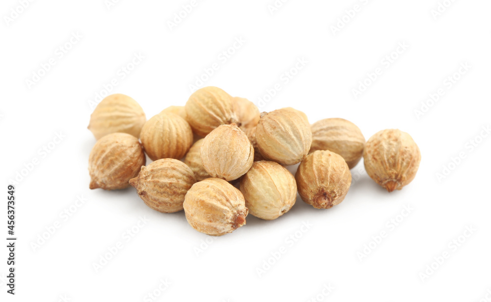 Heap of dried coriander seeds on white background, closeup