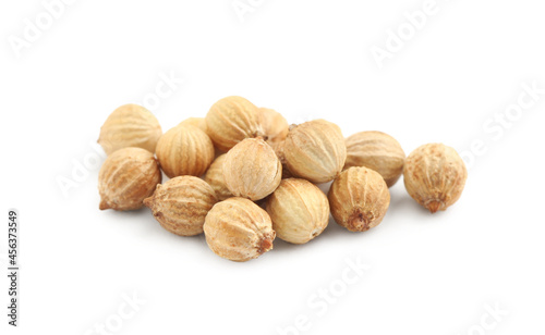 Heap of dried coriander seeds on white background, closeup