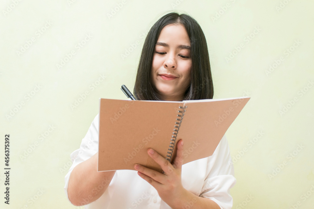 Asian girl writing homework notebook and online learning education concept Asian girl writing homework notebook and online learning education concept