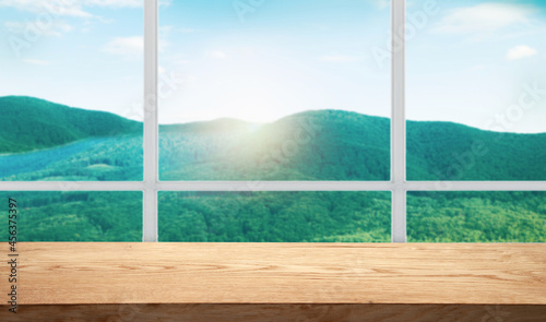 table background free space for your product and blurred landscape of mountains. Blue sky with sunlight.