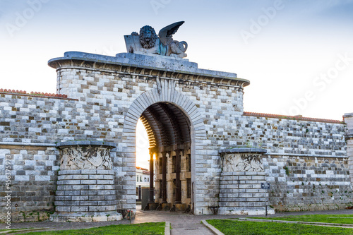 The San Marco gate in Leghorn, Italy at sunset photo