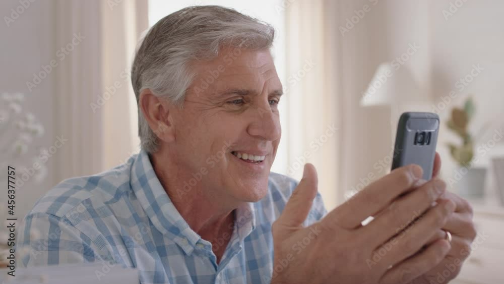 happy mature man having video chat using smartphone grandfather enjoying conversation with family sharing lifestyle chatting on mobile phone relaxing at home 4k happy mature man having video chat using smartphone grandfather enjoying conversation with family sharing lifestyle chatting on mobile phone relaxing at home 4k