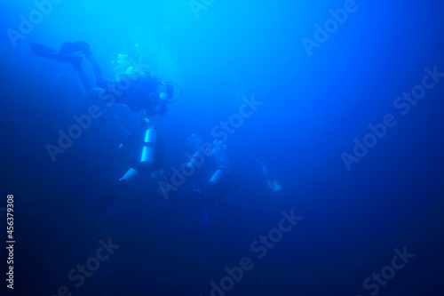 divers in the ocean  underwater sport active recreation in the deep ocean