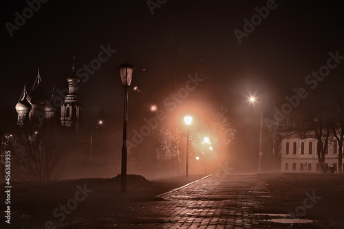 night in the park landscape, abstract view of the alley, trees and lights in the autumn blurred background