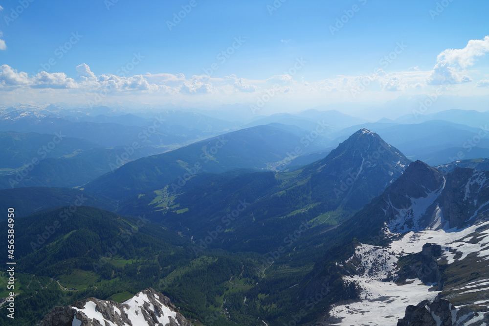 beautiful alpine landscape of the alpine valley seen from snowy Dachstein mountain in the Austrian Alps against the blue sky in Schladming-Dachstein region (Austria, Steiermark, Schladming)	