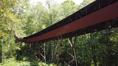 View of the coal conveyor from the Nuttallburg tipple up to the head house and coal mine entrance in New River Gorge National Park in West Virginia Appalachia. photo