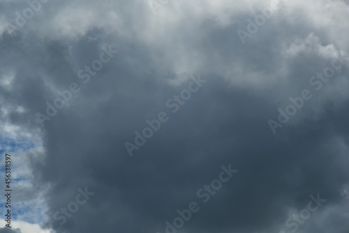 Gray and white rolling puffy clouds floating in the sky. Concept Storm Clouds Raining.