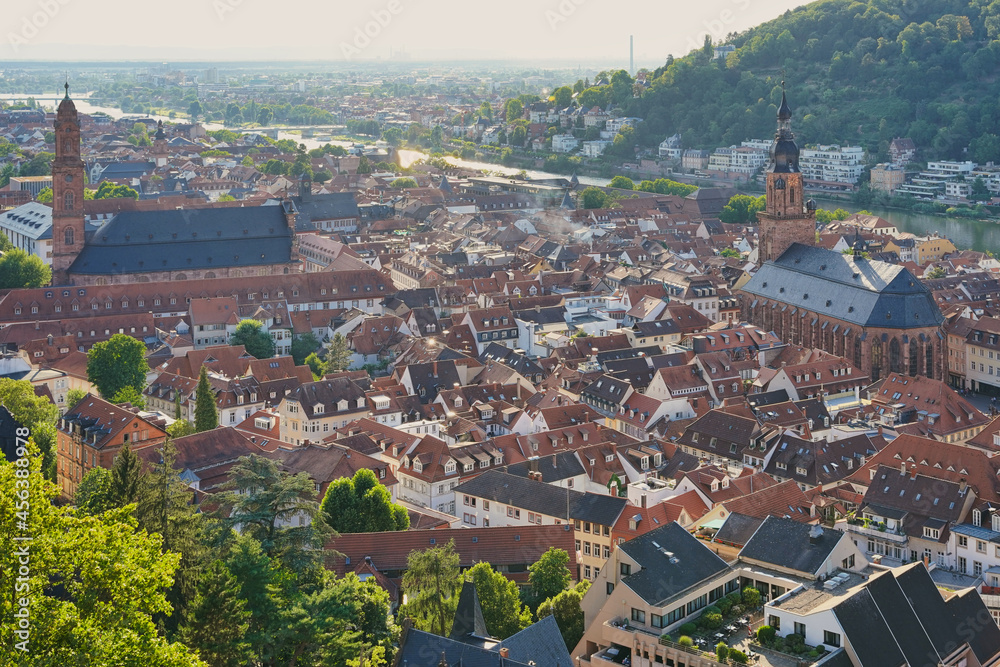 The historic city of Heidelberg with two churches and river Neckar in the evening sun. Germany.
