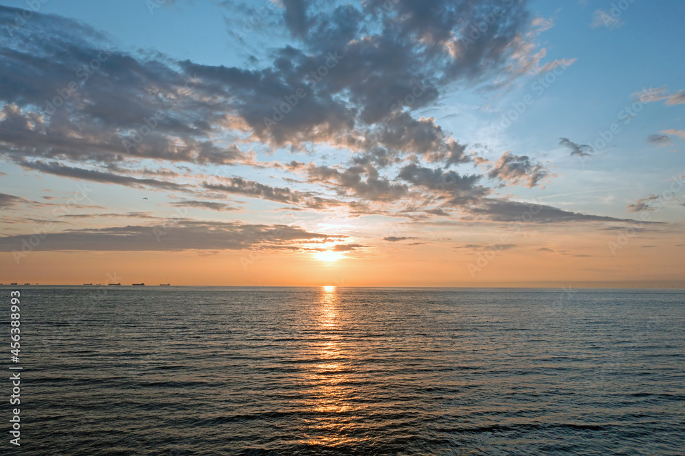 Aerial from a beautiful sunset at the North Sea with freighters at the horizon Aerial from a beautiful sunset at the North Sea with freighters at the horizon