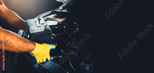 Technician replaced new battery of the car with copy space