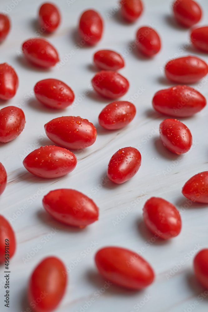 Set of cherry tomatoes on white marble table. Vegetarian food concept. Set of cherry tomatoes on white marble table. Vegetarian food concept.
