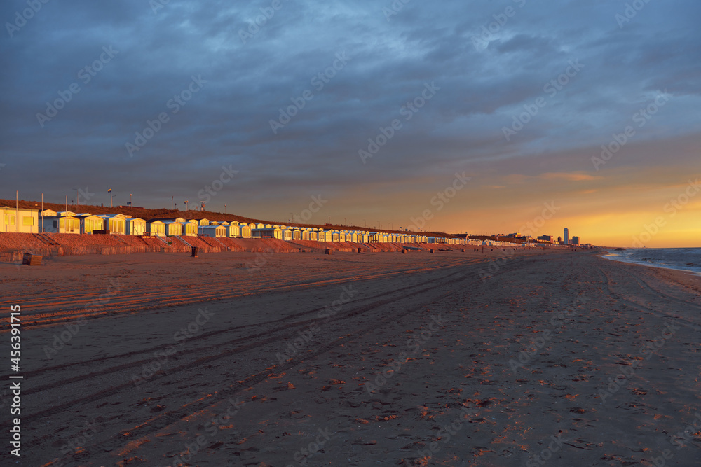 Golden beach cabins at Zandvoort in the Netherlands illuminated by the sunset