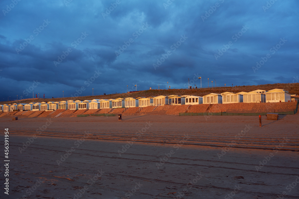 Golden beach cabins at Zandvoort in the Netherlands illuminated by the sunset