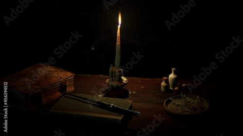Fantasy desk. Scene with a wand, books candlelight and ingredients over an old wooden table.
