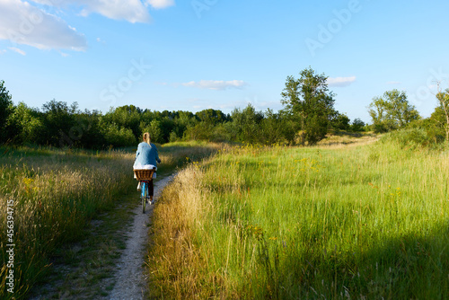 Woman with bicycle from behind on path next to the river Loire in Amboise France photo