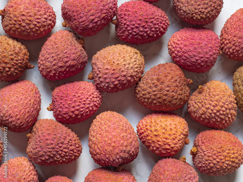 Fresh red lychee fruits on marble background, horizontal orientation