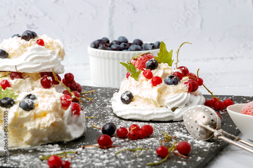 Anna Pavlova cake with currants, blueberries and strawberries
