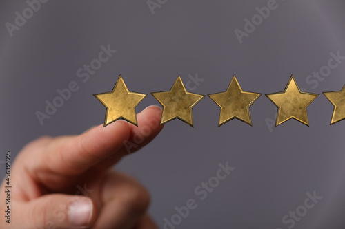 Customer hand touching to yellow illustration 5 stars virtual screening monitor for satisfaction evaluation