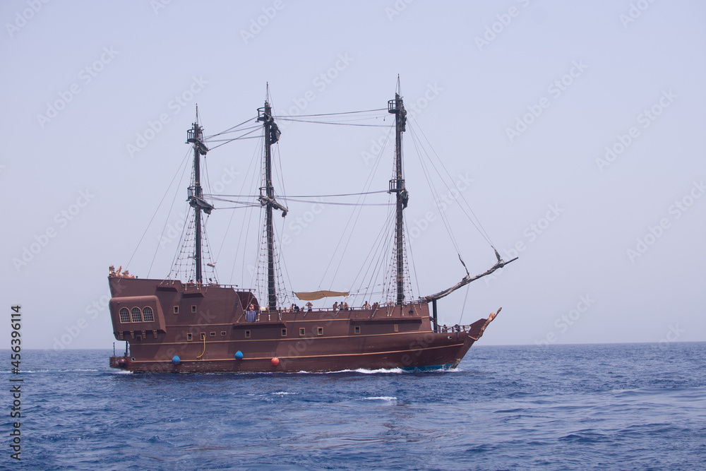 a sailing pirate ship entertains tourists by riding on the blue sea. a boat trip. - 05, August, 2021. Egypt, Sharm el Sheikh, red sea. a sailing pirate ship entertains tourists by riding on the blue sea. a boat trip. - 05, August, 2021. Egypt, Sharm el Sheikh, red sea.