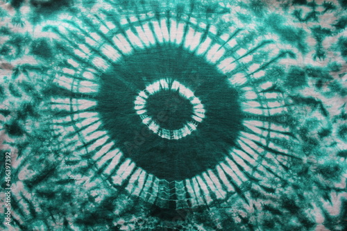 Fototapeta Naklejka Na Ścianę i Meble -  Tie dye green background with half circle layers of dye pattern fading from green to white dye fabric textile
