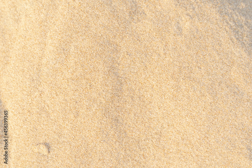 Sand texture background. Brown desert pattern on tropical beach.