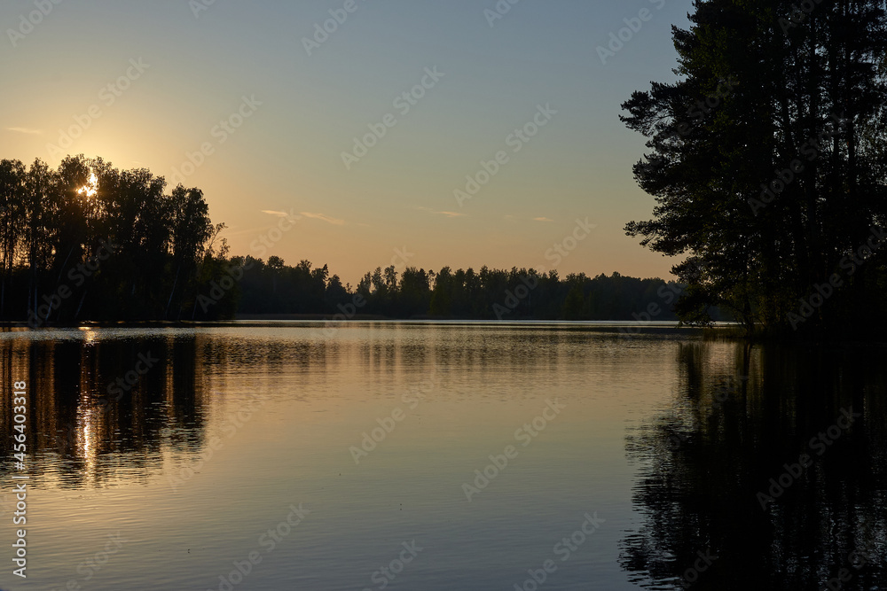 Sunset on the Vuoksa River, silhouettes of trees