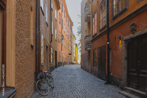 A narrow street iwith cobblestone pavement n the old part of Stockholm city - Gamla Stan. The bikes are parked on the site and the windows face each other