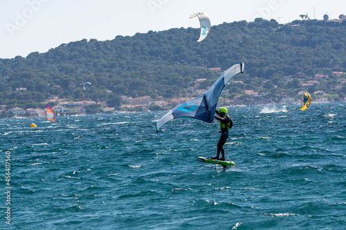 Hyeres, Almanarre beach, France, July 10, 2021. Extreem water sport - wing foil, kite surfing, wind surfindg, windy day on Almanarre beach near Toulon, South of France photo