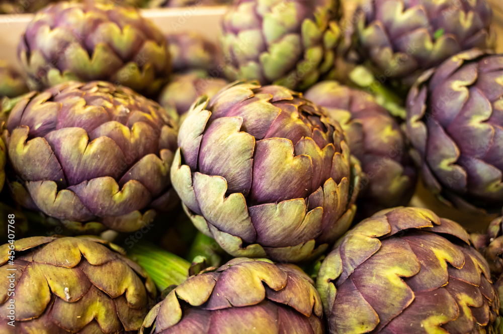 New harvest of French violet globe artichokes on weekly market in Provence, France New harvest of French violet globe artichokes on weekly market in Provence, France
