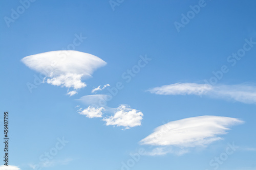 Lenticular Flying saucer clouds in blue sky - background or replacement