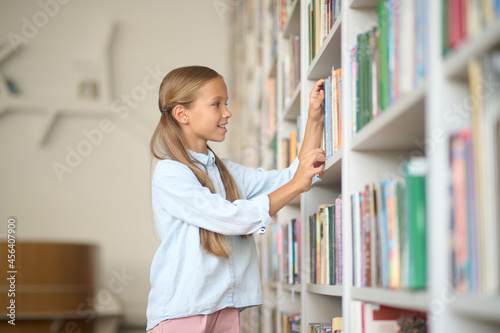 Young girl searching for the right books