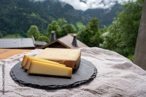 Cheese collection, French cow cheese comte, beaufort, abondance and french mountains village in Haute-Savoie on background photo