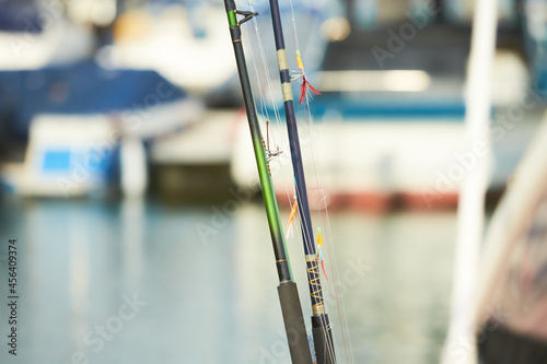 Fishing rods with hooks on the boat in natural setting. Closeup