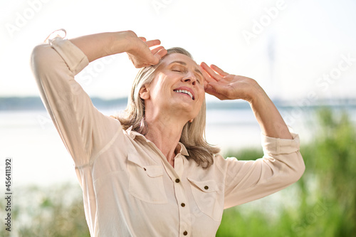 Foto Adult happy woman with closed eyes and smile