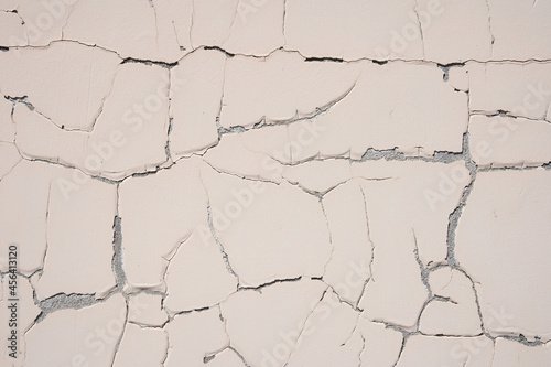 Background texture of a white cement wall with a crack. A crack in the old wall. High quality photo