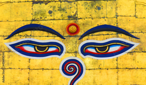 Swayambhunath Stupa's eyes, The eyes of Buddha, symbol the wisdom and enlightenment of Buddha's eyes on a golden background in Kathmandu, Nepal. photo