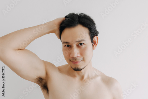 Happy Asian man show off his face apply skincare product.