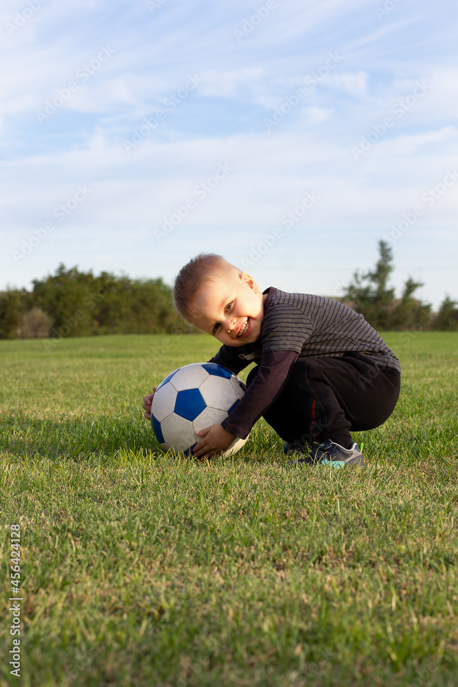 young little kid 3 years old enjoying happy playing football soccer at grass city park field posing smiling proud standing holding the ball in childhood sport passion and healthy lifestyle young little kid 3 years old enjoying happy playing football soccer at grass city park field posing smiling proud standing holding the ball in childhood sport passion and healthy lifestyle