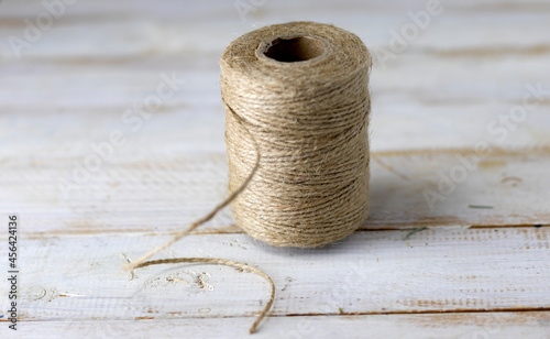 image of the rough, strong thread on a wooden table close-up