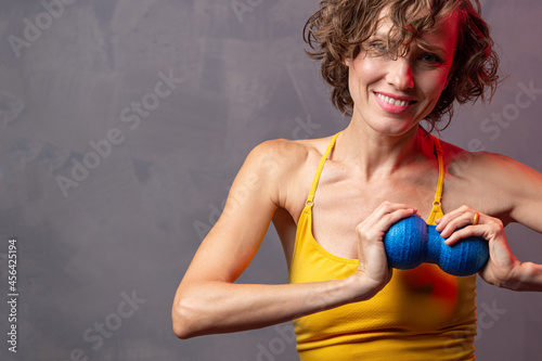 Woman with yoga props tools. Muscular fascial warm-up. Myofascial release	 photo