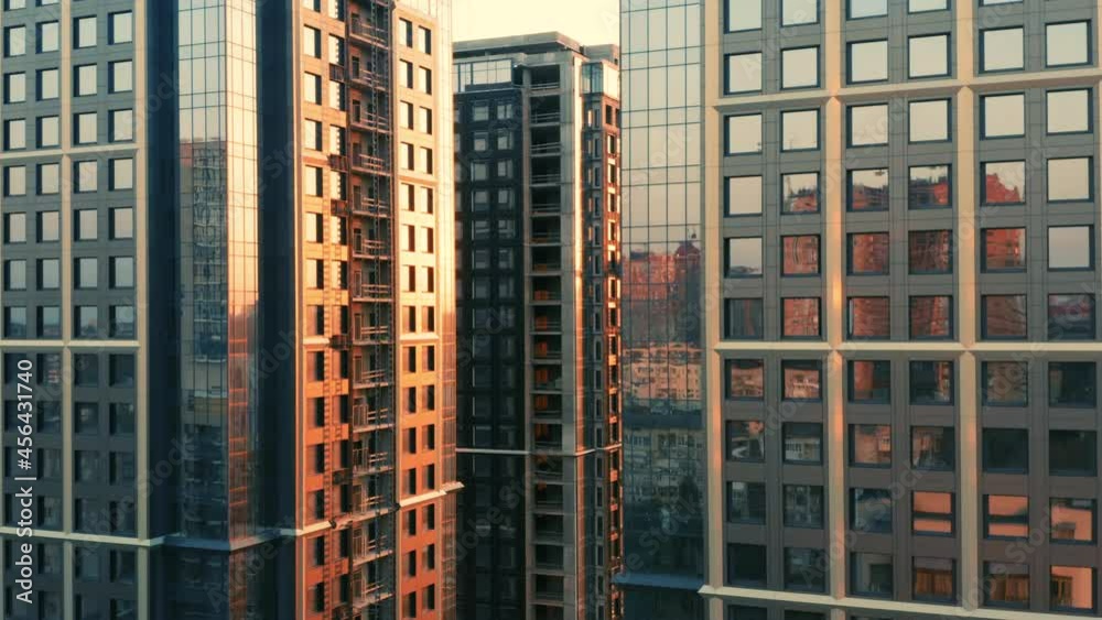 Aerial view of a group of newly built apartment skyscrapers in downtown at sunset