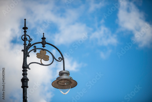 Metal lamppost on a Dublin street one day with blue skies without rain