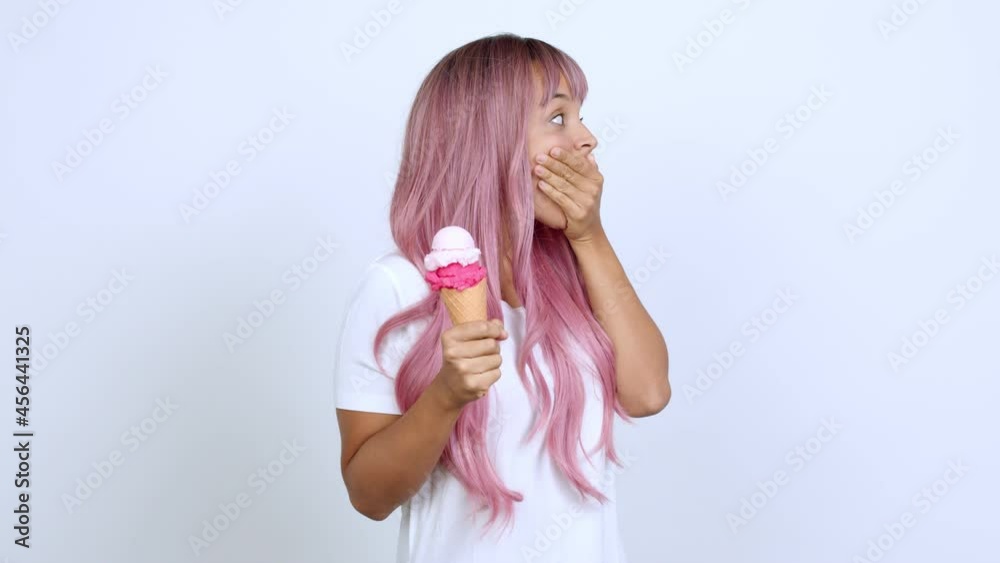 holding a cornet ice cream pointing to the side and presenting a product while smiling over isolated background holding a cornet ice cream pointing to the side and presenting a product while smiling over isolated background